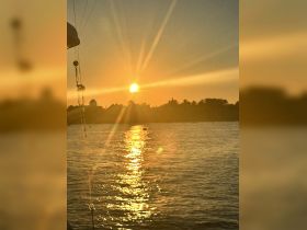 A stunning sunset view from a boat, with golden rays reflecting on the water — perfect for capturing the serene beauty of evening cruises.