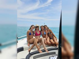 A group of friends enjoys a sunny day on the boat, capturing the essence of summer fun and friendship on the water.