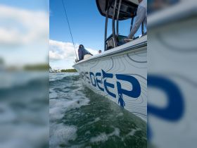 A group of anglers prepares for a fishing adventure aboard a sleek boat, showcasing the excitement of a day on the water.