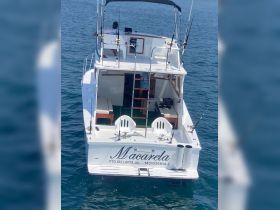 A view of the back of the 'Macarela' yacht, showcasing its spacious deck and fishing equipment, ideal for fishing trips in Puerto Vallarta.