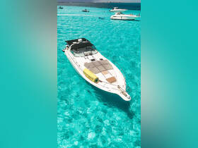 A stunning aerial view of a sleek yacht anchored in crystal-clear turquoise waters, perfect for luxurious day trips and relaxation on the water.