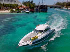 A sleek yacht navigates through stunning turquoise waters, showcasing a vibrant coastal scene — perfect for adventure seekers and boat enthusiasts.