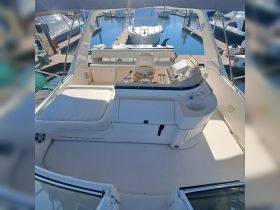 A clean and spacious interior view of a boat's helm and seating area, showcasing the perfect setup for a comfortable day on the water.