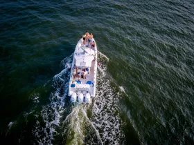 A lively group enjoys a day on the water aboard a boat, showcasing the fun and excitement of on-water activities.