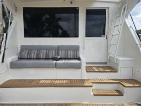 Interior view of a comfortable seating area on a boat, featuring stylish cushions and a clean design, perfect for relaxing while cruising.