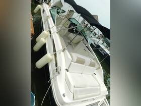 A well-appointed interior view of a boat's seating and helm area, showcasing comfortable lounge space ideal for relaxing on the water.