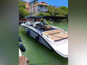 A sleek boat docked in calm waters, showcasing its modern design and comfortable seating — perfect for a day on the water.