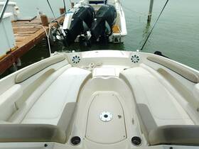 A clean and spacious interior view of a boat's seating area, showcasing comfortable lounge space ideal for relaxation on the water.