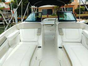 A spacious and well-appointed interior of a boat featuring comfortable seating and a clean helm area, perfect for relaxing during a day on the water.
