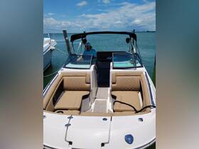 A well-appointed boat interior featuring comfortable seating and a helm, perfect for relaxing on the water. Ideal for day trips and family outings.