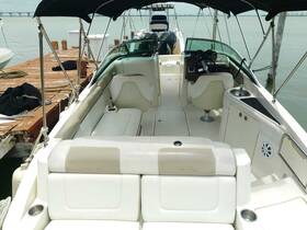 Interior view of a well-appointed boat cabin featuring comfortable seating and a helm, perfect for relaxing on the water.