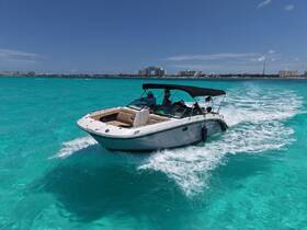 A sleek speedboat glides through the stunning turquoise waters, showcasing a perfect day for adventure on the water.