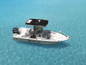 Aerial view of a sleek speedboat named 'Dauntless II' cruising through crystal-clear turquoise waters, perfect for a day of adventure on the sea.