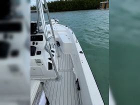 A detailed view of the interior helm and seating area of a boat, showcasing the modern console and spacious layout, perfect for navigation and comfort on the water.