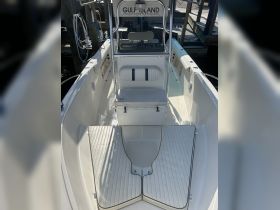 Interior view of a well-equipped boat featuring seating and a helm area, ideal for charters and day trips on the water.