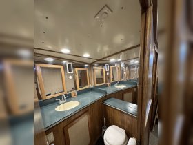 Interior view of a boat's bathroom, featuring dual sinks and ample storage, ideal for comfort during voyages.