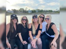 A group of friends enjoys a fun day on the water, celebrating together aboard a boat — perfect for memorable outings and gatherings.