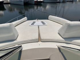 A spacious and inviting seating area on the front deck of a boat, perfect for relaxing and enjoying the views while out on the water.