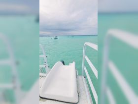 A view of a water slide on a boat, overlooking the serene turquoise waters — perfect for fun-filled days on the water.