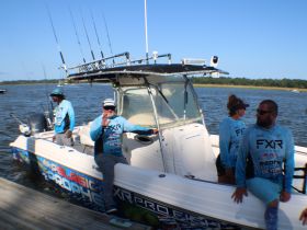 A group of anglers prepares for a fishing adventure on a boat, showcasing camaraderie and excitement for a day on the water.