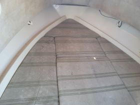 Interior view of a boat cabin featuring comfortable seating, ideal for relaxation while on the water.