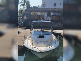 A sleek speedboat docked at a marina, showcasing its clean lines and modern design — perfect for a day on the water.