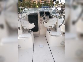 The interior of a boat showcasing the helm and seating area, perfect for navigating the waters in comfort.