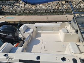 Interior view of a well-equipped boat featuring comfortable seating and a helm area, perfect for a day on the water.