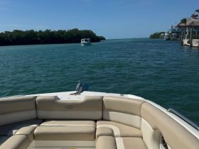 A view of the comfortable seating area inside a boat, showcasing the helm and inviting atmosphere for a day on the water.