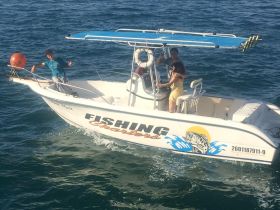 A couple enjoys a fishing trip on a charter boat, showcasing the excitement of ocean adventures.