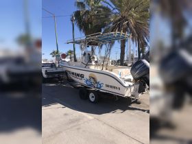 A fishing boat parked at the dock, showcasing its sleek design and ready for a day on the water.
