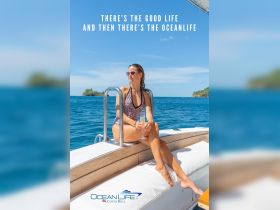 A woman enjoys a refreshing cocktail while relaxing on the deck of a boat, showcasing the luxurious ocean life experience in Costa Rica.