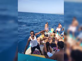 A lively group enjoys a fun day on the water, celebrating and socializing aboard a boat — perfect for summer parties and group outings.