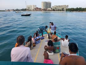 A lively group enjoys drinks aboard a boat, creating a fun atmosphere perfect for parties and celebrations on the water.