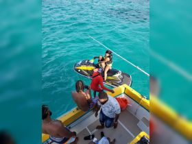 A group enjoys an exciting day on the water, with friends riding a jet ski and others relaxing on the boat — perfect for adventure seekers and fun-loving travelers.