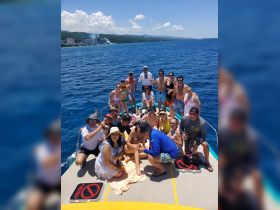 A lively group enjoys a fun day on the water, celebrating together aboard a boat — perfect for group outings and memorable adventures.