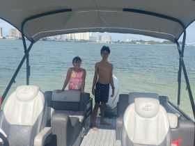 Two children enjoy a sunny day on a boat, showcasing the fun and excitement of family outings on the water.