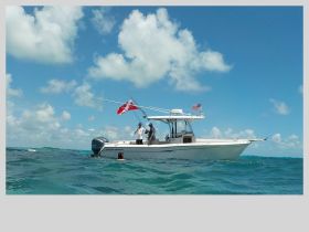A group of divers prepares for an underwater adventure next to their boat, showcasing the excitement of ocean exploration.