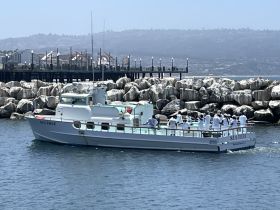 The 'Sea Trek' boat is seen underway with a group of guests enjoying the experience, making it a perfect setting for a day on the water.