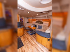 Interior view of a cozy boat cabin featuring comfortable seating and a stylish lounge area, perfect for relaxing during your nautical adventures.