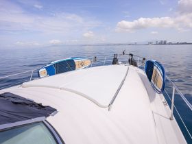 A serene view of paddleboards resting on the deck of a boat, showcasing the perfect setup for water activities on calm waters.