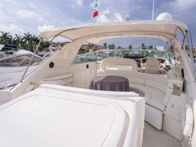 A spacious and elegantly designed interior of a boat featuring comfortable seating and a well-equipped helm, perfect for relaxing and navigating on the water.