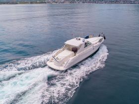 A stunning aerial view of a sleek yacht cruising through calm waters, showcasing its elegant design and perfect for luxurious outings on the sea.