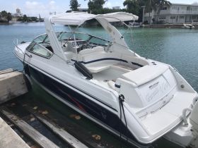 A sleek speedboat docked in calm waters, showcasing its elegant design and features, perfect for a day on the water.