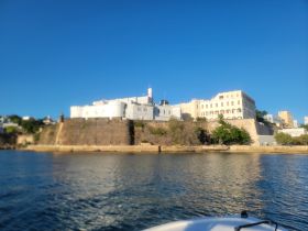 A blurred view of a coastal structure from a boat, lacking clarity and detail.