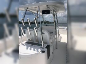 A clean and modern helm area of a boat featuring comfortable seating and a well-equipped console, perfect for a day out on the water.