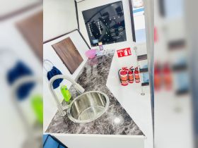 Interior view of a boat's cabin featuring a sleek sink and control panel, showcasing the functional design of onboard spaces.