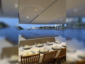 Elegant dining setup on a yacht, featuring a beautifully arranged table with fine dinnerware, perfect for upscale dining experiences on the water.
