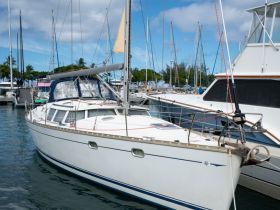 A beautiful sailboat docked in a marina, surrounded by other vessels under a clear blue sky — perfect for sailing adventures.