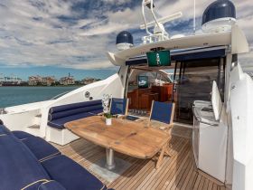 A beautifully designed interior of a yacht featuring comfortable seating and a dining area, perfect for relaxing and enjoying meals while on the water.